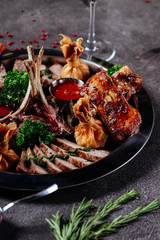 Mixed grilled meat platter. Assorted delicious grilled meat with vegetable. Mixed grilled meat with pepper sauce and vegetables.