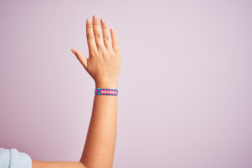 Arm of model woman with beautiful handmade colorful bracelet on wrist
