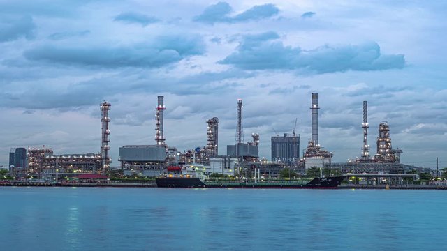  4K (3840p) Energy industry with blue sky background, timelapse technology production of petrol chemical at twilight, Global warming background is save energy and environment concept.