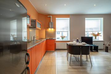 Modern interior of spacious light studio apartment. Kitchen set.