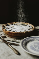 blueberry pie on a vintage dish on a dark background