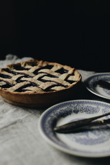 blueberry pie on a vintage dish on a dark background