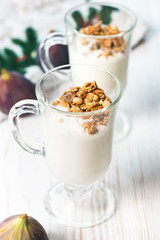 Crispy muesli in a glass with fresh yogurt and fresh figs, morning Breakfast, light snacks. Breakfast cereals isolated on white background, selective focus, top view
