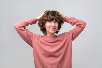 Smiling curly thinking woman looking up dreaming or planning