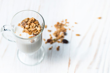 Crispy muesli in a glass with fresh yogurt, morning Breakfast, light snacks. Breakfast cereals isolated on white background, selective focus, top view