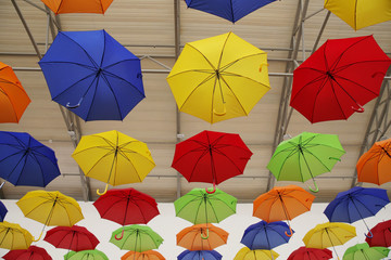 Fototapeta na wymiar colorful umbrellas on a background. Abstract background with red, yellow, green, blue, orange umbrellas..