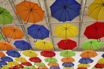 Fototapeta na wymiar colorful umbrellas on a background. Abstract background with red, yellow, green, blue, orange umbrellas..