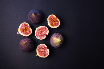 Fresh ripe figs on a dark table. Healthy Mediterranean figs. Fresh figs on black background....