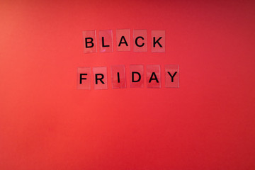 Fototapeta na wymiar Black Friday letters on red background. Flat Lay
