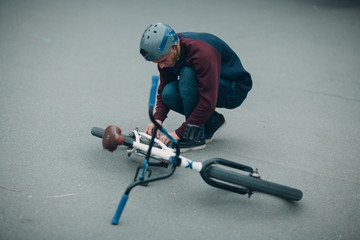 Professional young sportsman cyclist with bmx bike at skatepark