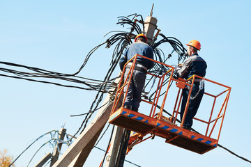 power electrician lineman at work on pole