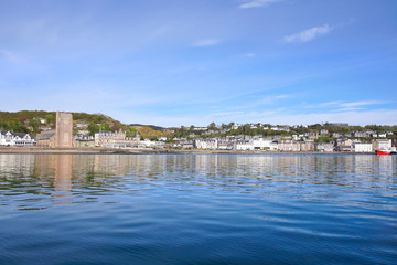 Fototapeta na wymiar Oban harbour seen from the water. Oban has a busy port with many ferry departures.