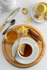 Tea cup with lemon and honey on a white background. Hot tea cup isolated, top view flat lay. Flat lay. Autumn, fall or winter drink. Copy space.