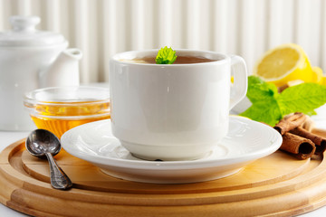 Cup tea with lemon and honey on a white background. Hot tea cup isolated, top view. Autumn, fall or winter drink. Copy space.