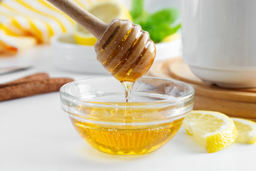 Golden natural honey autumn winter hot drink ingredient glass bowl honey spoon seasonal