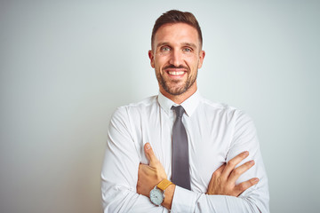 Young handsome business man wearing elegant white shirt over isolated background happy face smiling with crossed arms looking at the camera. Positive person.