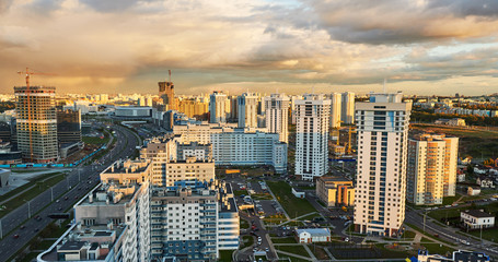 Fototapeta premium Panorama of urban district in rays of sunset light