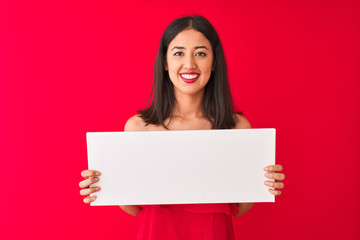 Naklejka premium Young beautiful chinese woman holding banner standing over isolated red background with a happy face standing and smiling with a confident smile showing teeth