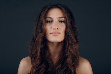 Portrait of beautiful young brunette woman with healthy hair