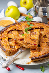 Sliced apple pie with cinnamon.