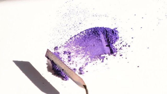 Violet eye shadows smear on white background. Cosmetic concept. 