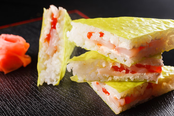 Triangular pieces. Japanese food, tasty of meal for lunch. Seafood. Sushi with eel, salmon, trout, tuna black background.