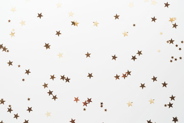 Golden glitter, confetti stars isolated on white background. Christmas, party or birthdau...