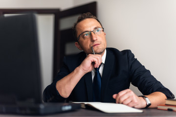 Sad man paying bills on his laptop