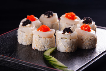 Japanese food, tasty of meal for lunch. Seafood. Sushi with eel, salmon, trout, tuna black background.