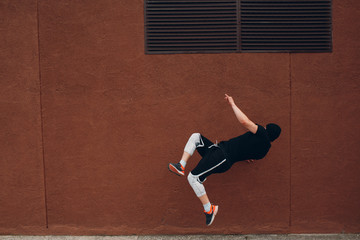Parkour young man making acrobatic trick and flip jumping high