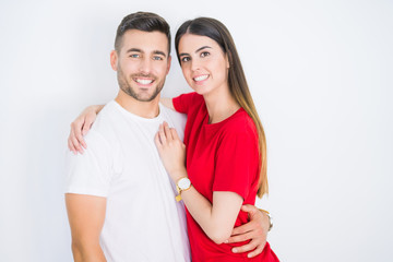 Fototapeta premium Young beautiful couple in love hugging over white isolated background