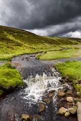 Dark clouds over Ford at Fore Gill Gate on the Bleaberry Gill stream near Langthwaite North Yorkshire England