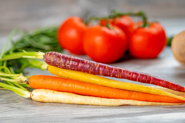 Close up of carrots along with other vegetables in the background