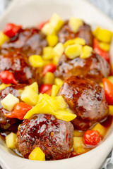 hors d'oeuvresof meatballs with colorful peppers servers as an appetizer