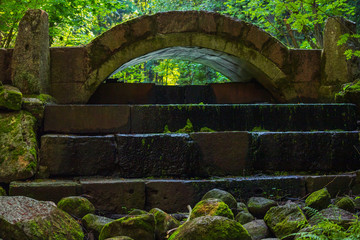 small stone bridge in park Ensemble Sergievka, Saint-Petersburg, Russia