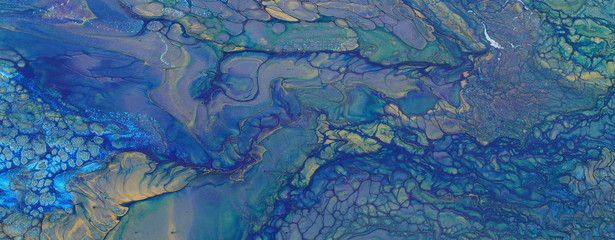 art photography of abstract marbleized effect background. blue and gold creative colors. Beautiful paint.