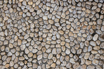 Natural photo texture of tiny pebble, top view background. White pebbles in grey sand top view. Rounded marble paving