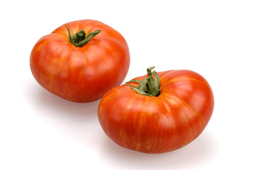 Two red-orange organic tomatoes.