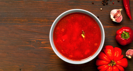 Mexican soup with chili pepper on wooden background. Close-up