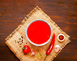 Mexican soup with chili pepper on wooden background