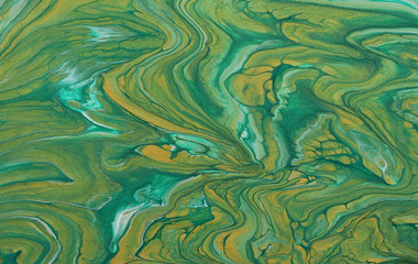 art photography of abstract marbleized effect background. emerald green, turquoise and gold creative colors. Beautiful paint.