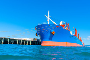 Bright blue and red cargo ship in port