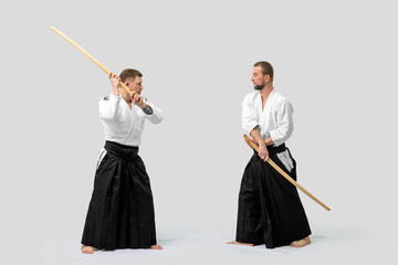 Two caucasian men are practicing aikido with Bokken (isolation path included)
