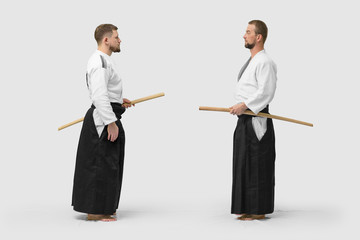 Two caucasian men are practicing aikido with Bokken (isolation path included)