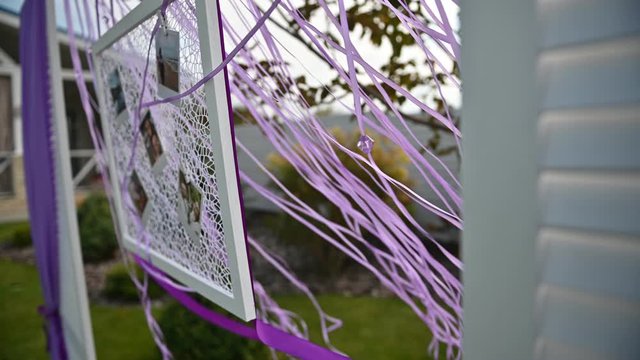 Wedding ceremony decoration on wind. Wind blows colorful ribbons in spring sunlight