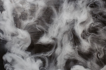  blue smoke on a black wooden background. texture