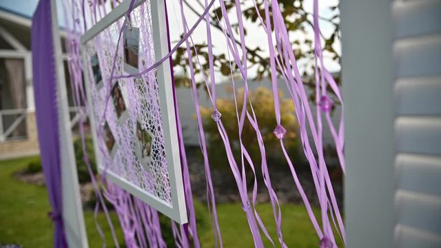 Wedding ceremony decoration on wind. Wind blows colorful ribbons in spring sunlight