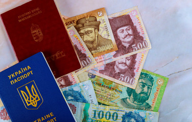 The Hungarian passports and Ukrainian passport with money banknotes forints