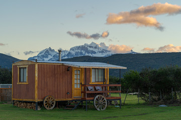 Rustic cabin with snowy mountains in the back