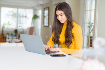 Beauitul young woman working using computer laptop concentrated and smiling
